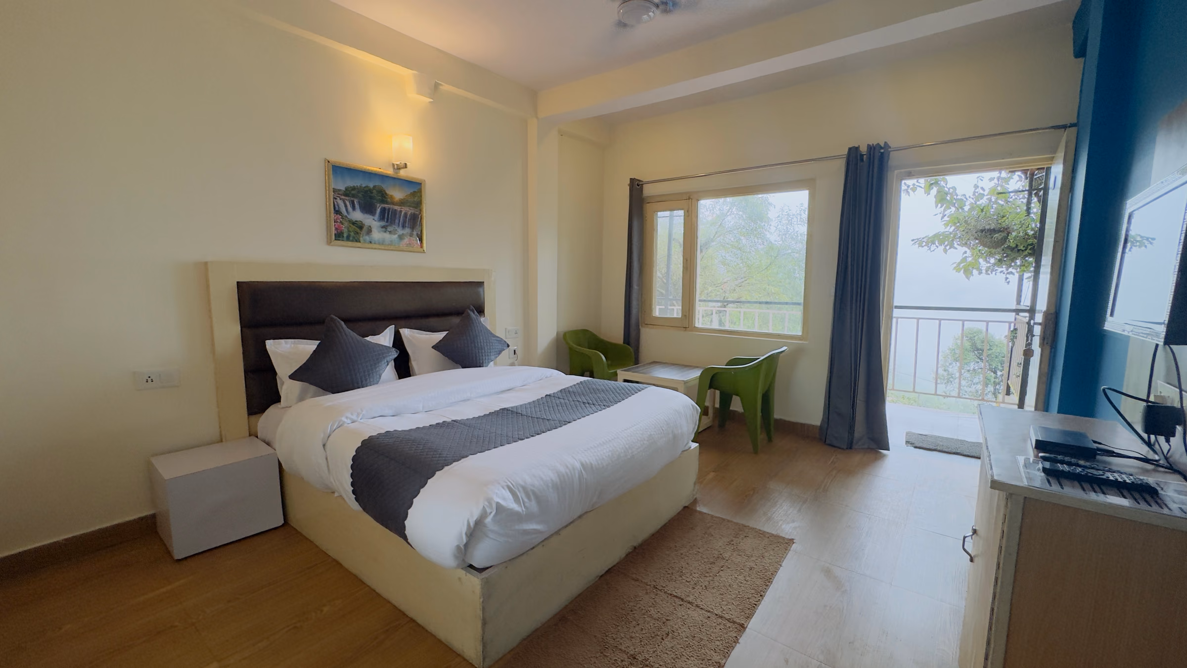 Deluxe room 205 with curtains drawn back from the window