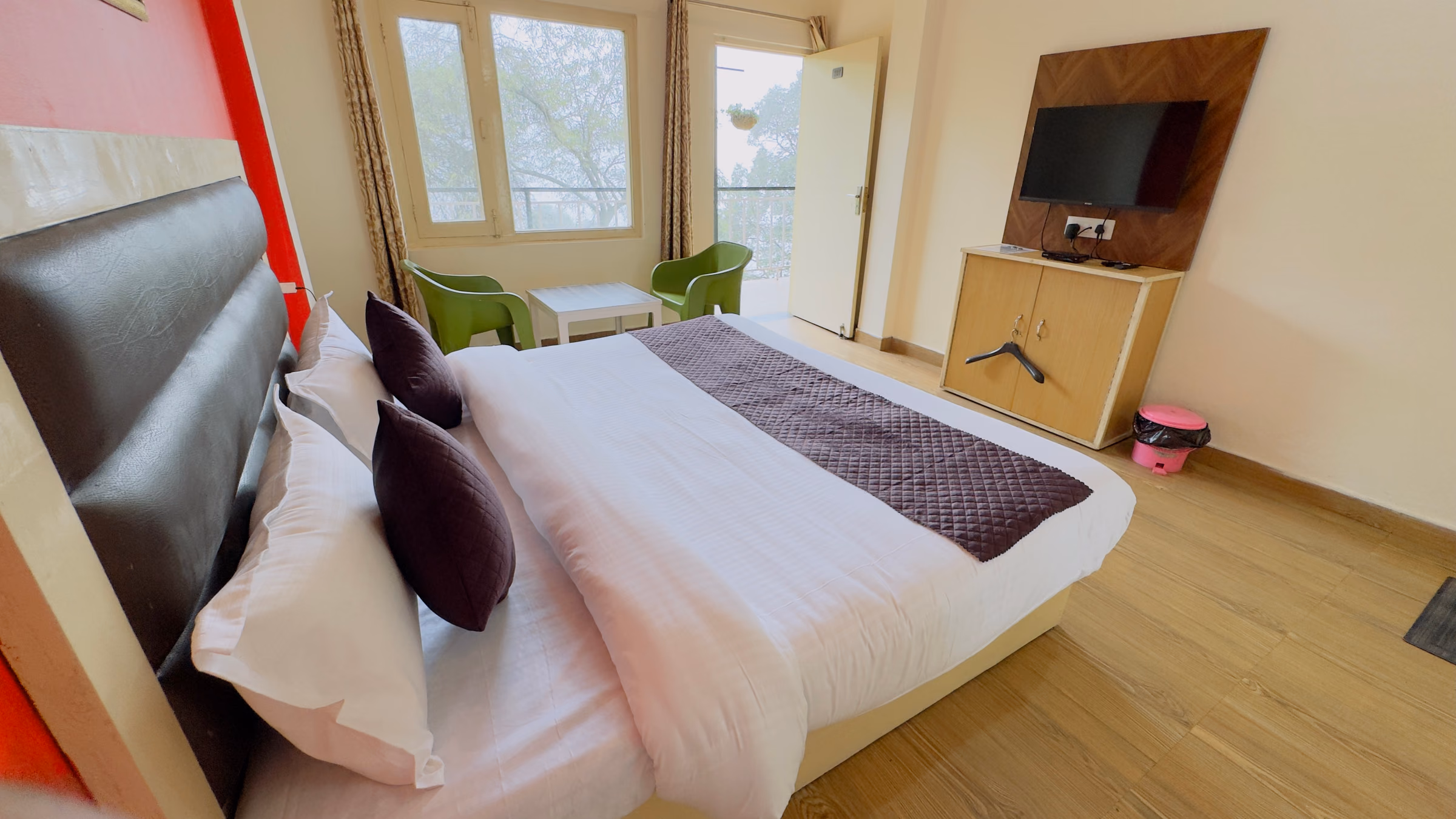 Deluxe room 207 with twin windows and seating chairs