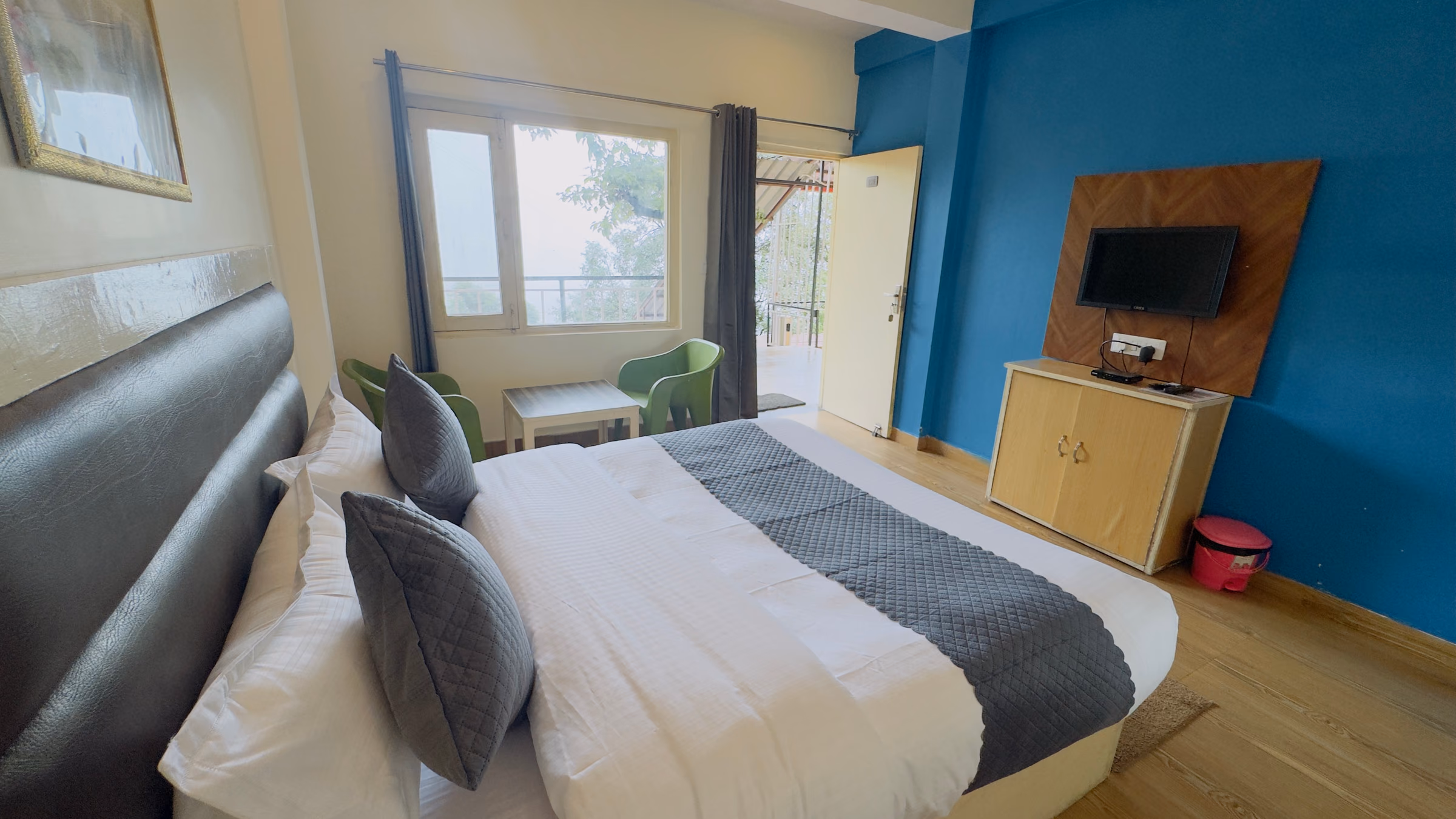 Bed and furnishings in Deluxe room 205