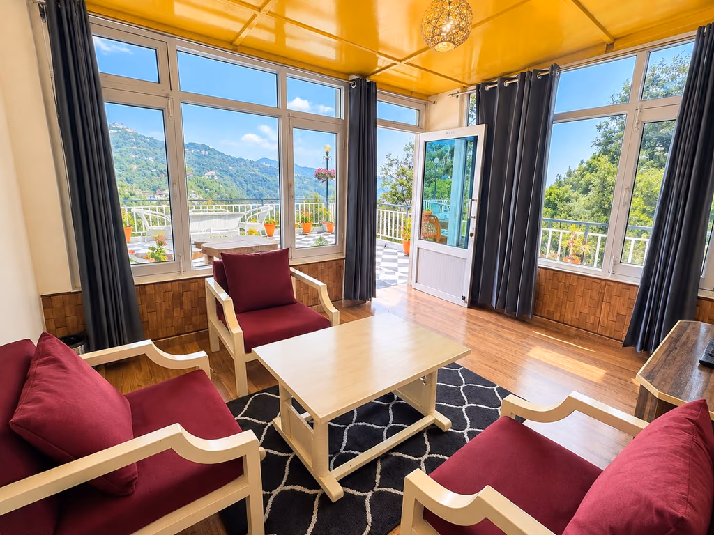 Seating area in Luxury King room 101 with the valley through full height windows
