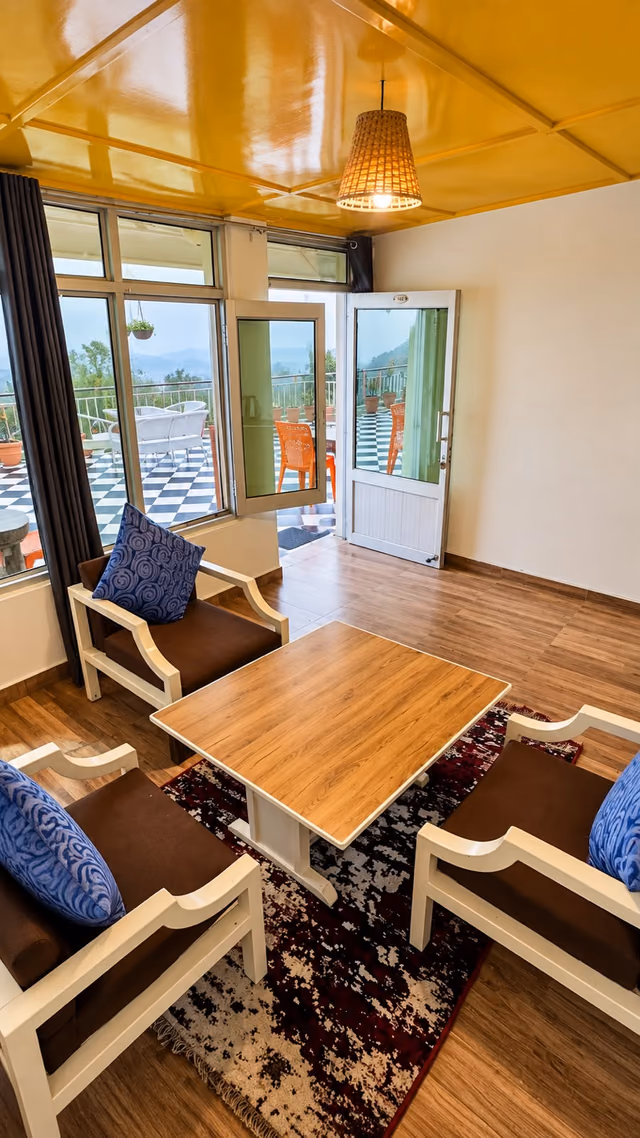 Seating area in Luxury King room 104 with doors onto the terrace