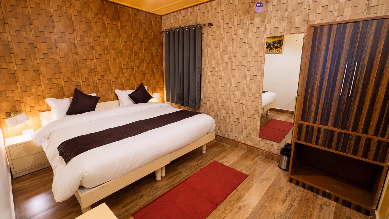 Wood-panelled bed area in room 104, Luxury King