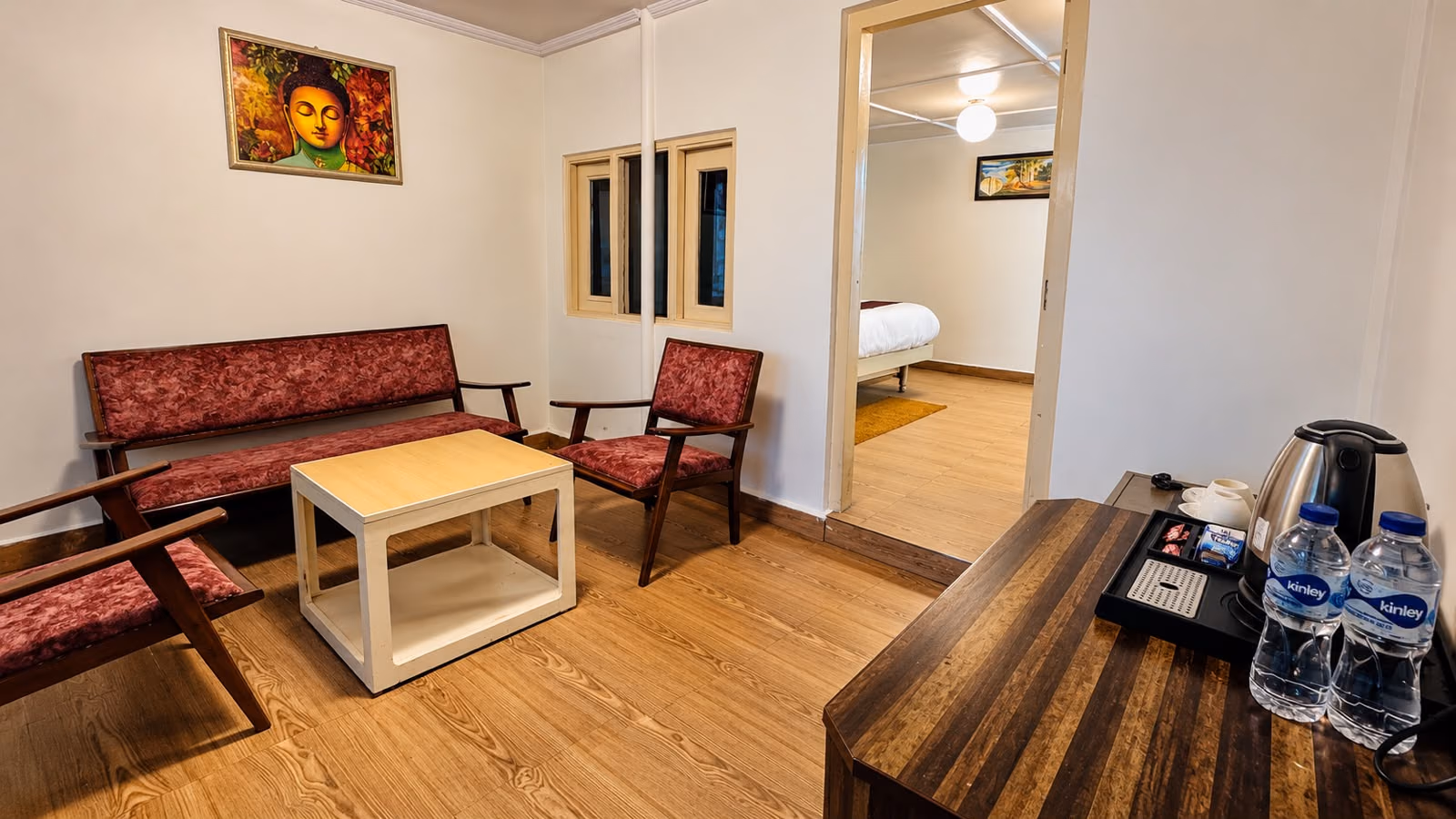 Bed with yellow accents in room 105, Luxury King